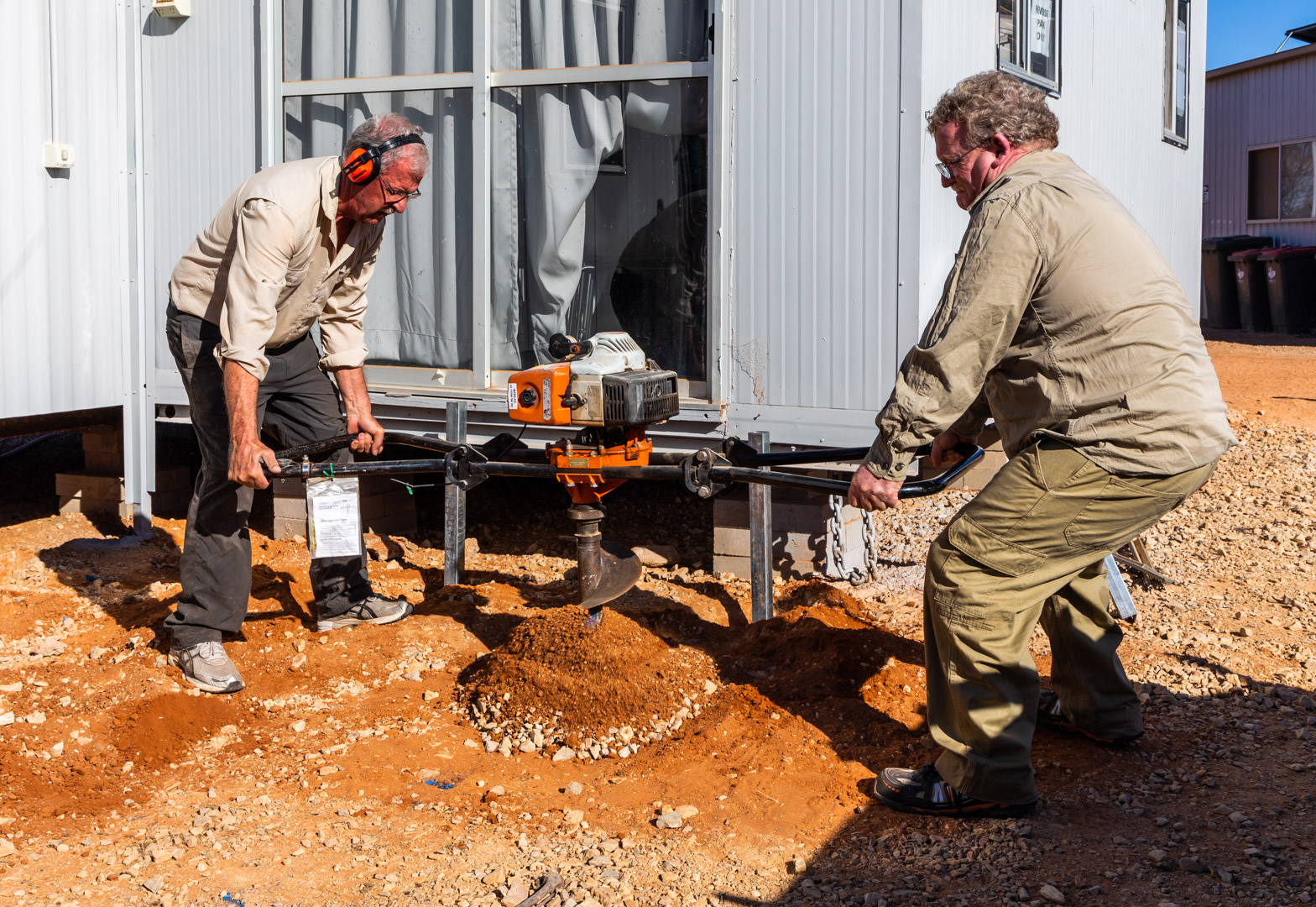 In 2018 we built a deck for the education room. Robin Stewart & John Crompton drilling the stump holes for the deck.