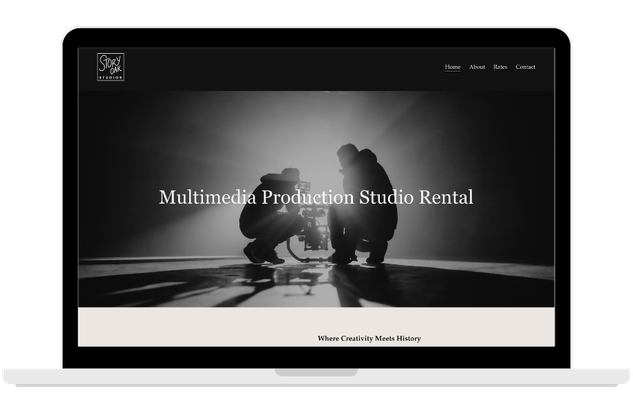Laptop displaying a website for a multimedia production studio rental, with a black and white background image of two people working with filming equipment.