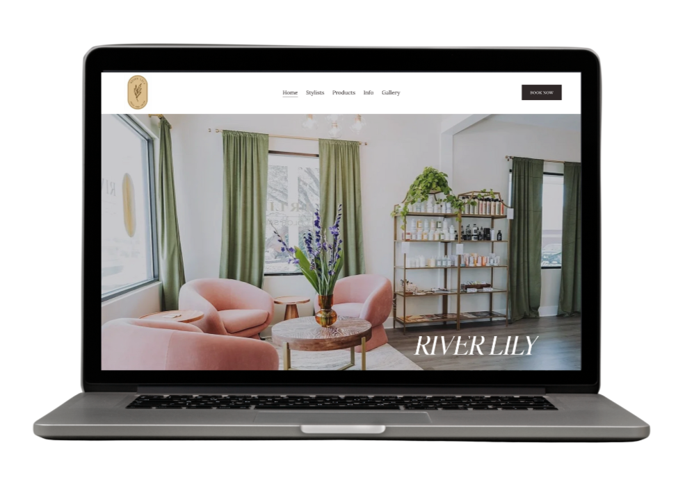 Laptop screen displaying interior of a boutique with pink chairs, green curtains, a wooden table with a vase of flowers, and a gold bookcase.