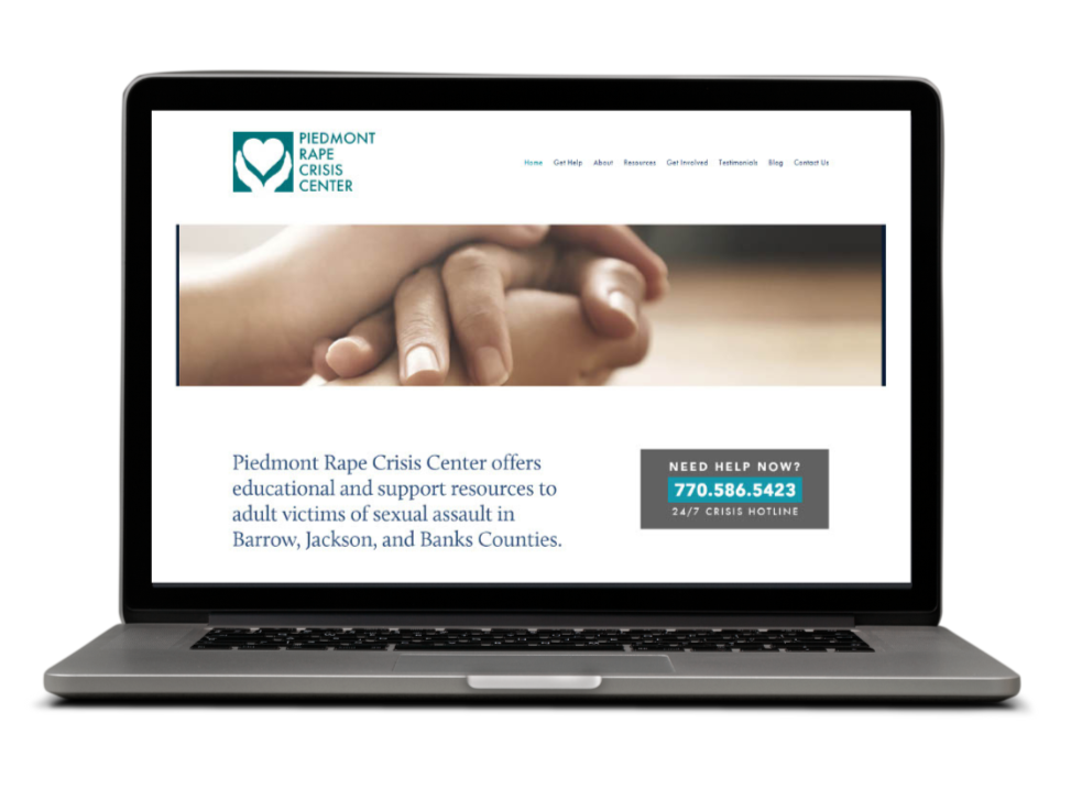 Laptop displaying the Piedmont Rape Crisis Center website, which offers resources for adult victims of sexual assault in several counties, with a contact hot line number.