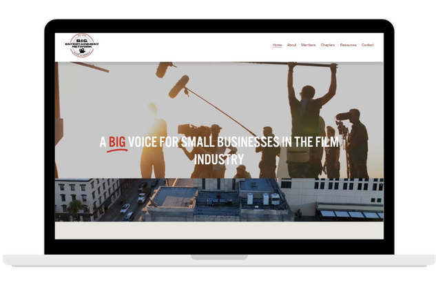 Laptop screen displaying a film industry website with a background of filmmakers and crew working outdoors at sunset.