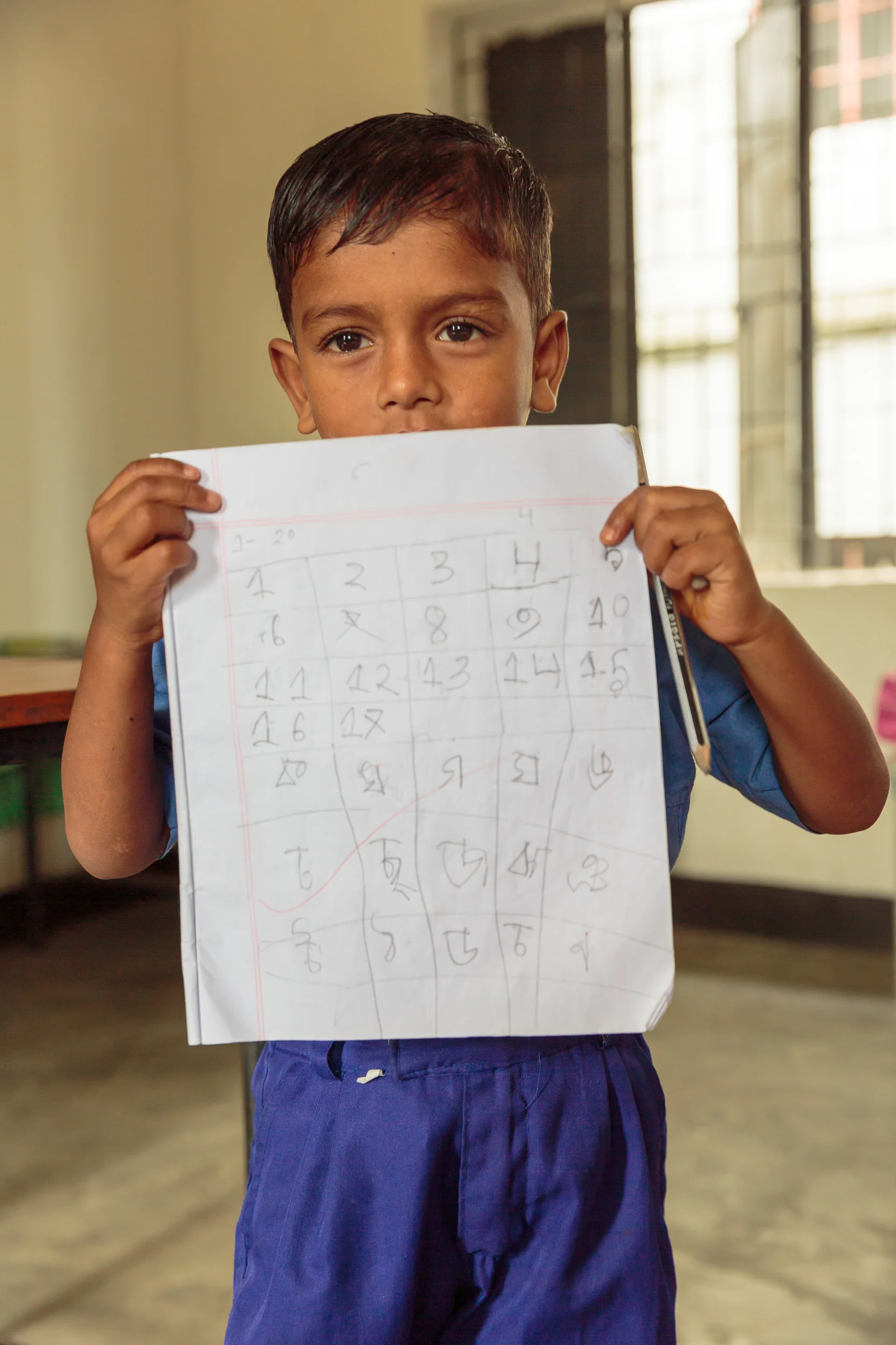 Boy holding class work