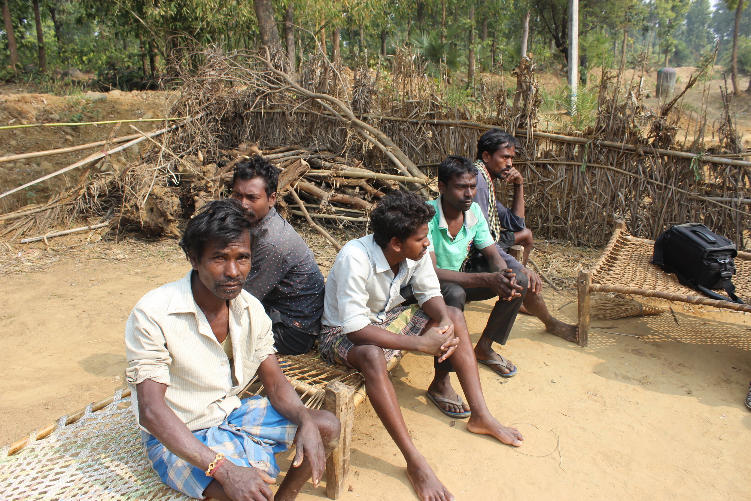  The sitting men (chief on the left) are bricklayers taking a break to join the meeting. 