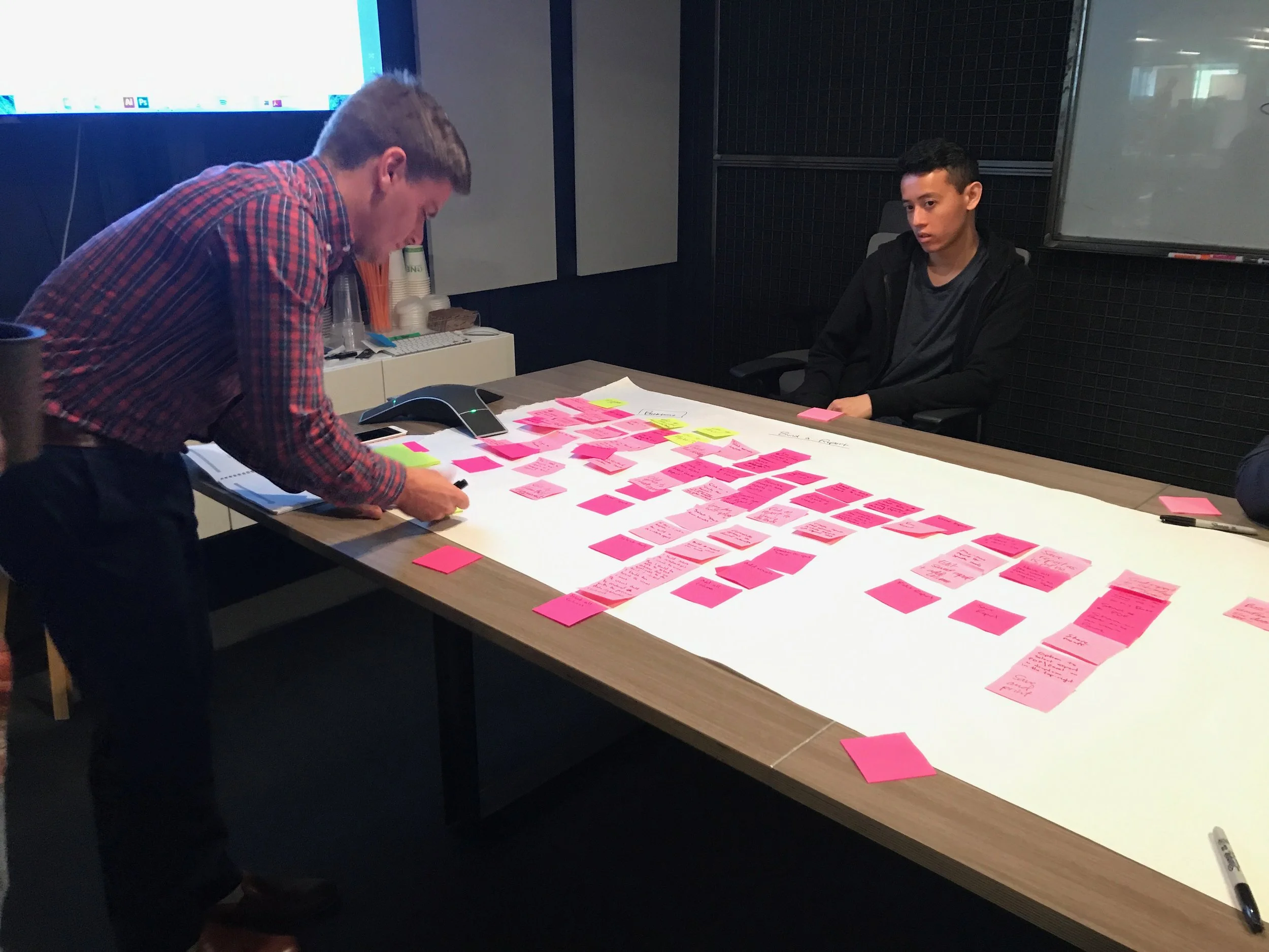As a squad, we all began to story map our user's journey in creating a report. Left to Right: Sam Meyer (Lead Engineer) &amp; Tony Dihn (FE Engineer)