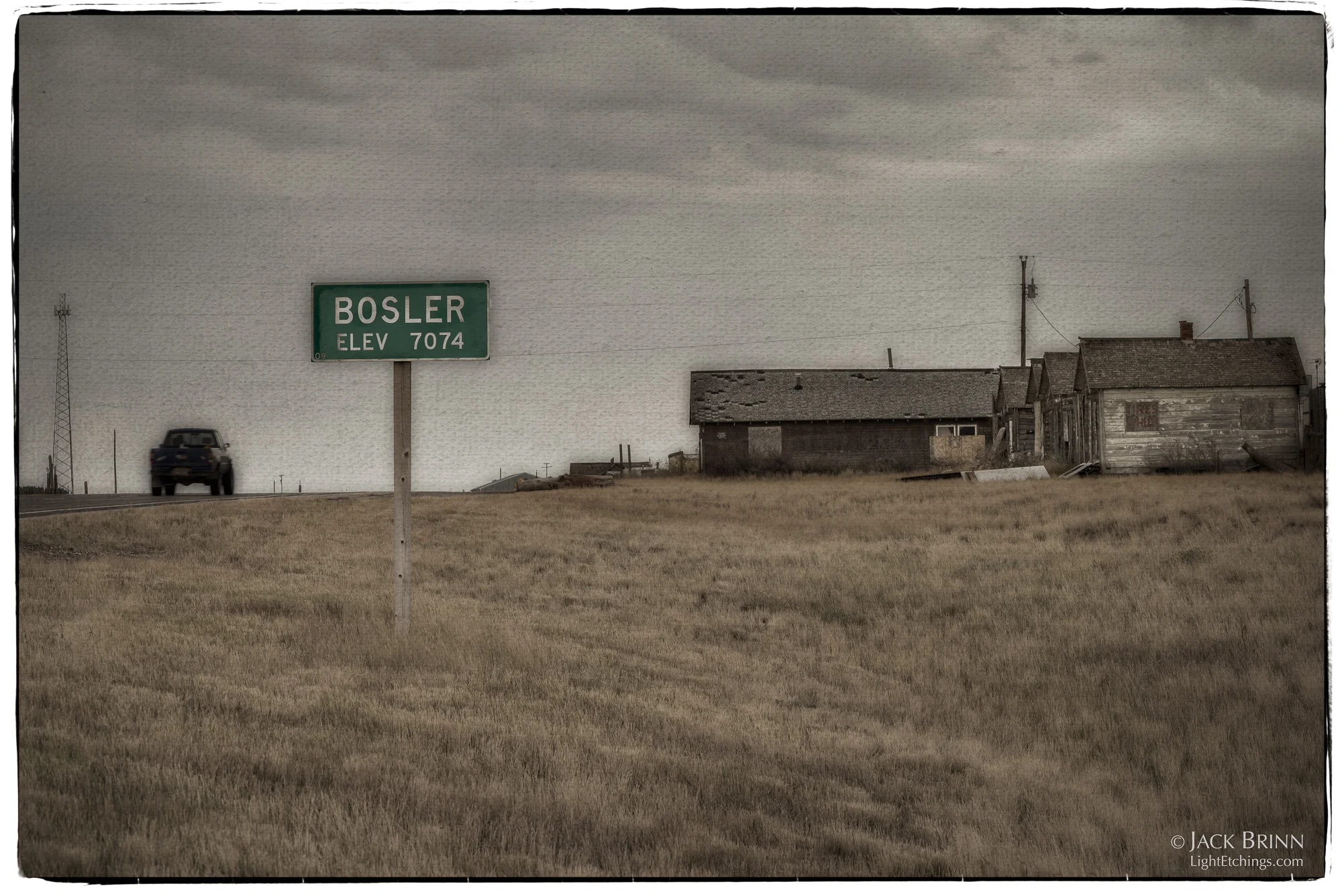 The truck is doing what most vehicles do in Bosler, passing through without slowing. The four small buildings on the right are the remains of the “motel”.