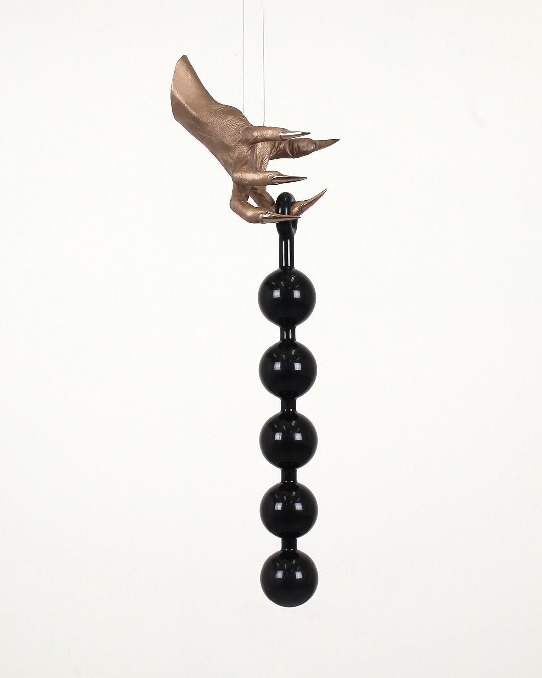 My work draws on the restrained elegance of bronze, silk, and glass alongside the queer-coded materiality of leather, rubber, chains, deconstructed bedsheets, and jock straps to build a distinct visual vocabulary that balances austerity with sensuali