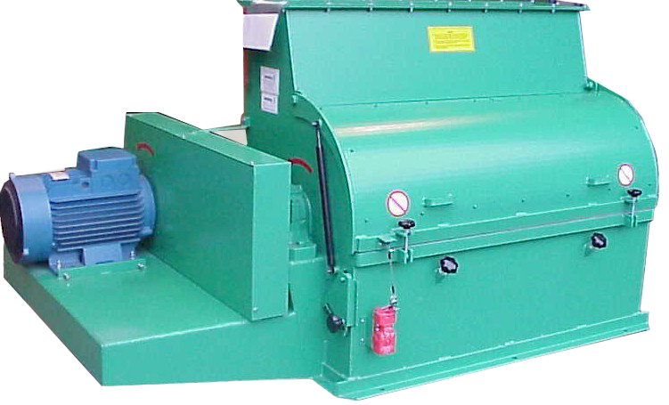 Large green industrial machine with electric motor on left, gauges and safety labels, used for processing or manufacturing.