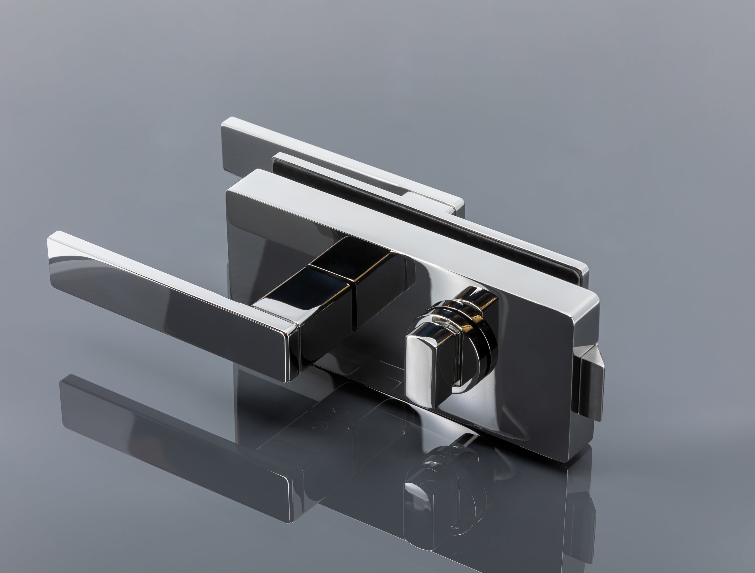 Close-up of a modern, silver faucet with a sleek, minimalist design, placed on a gray countertop.