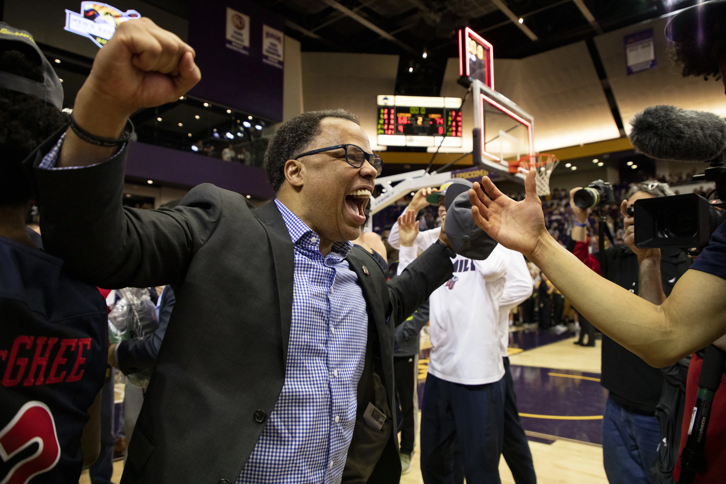 Coach Ritchie McKay celebrates winning the men's basketball ASUN championship.