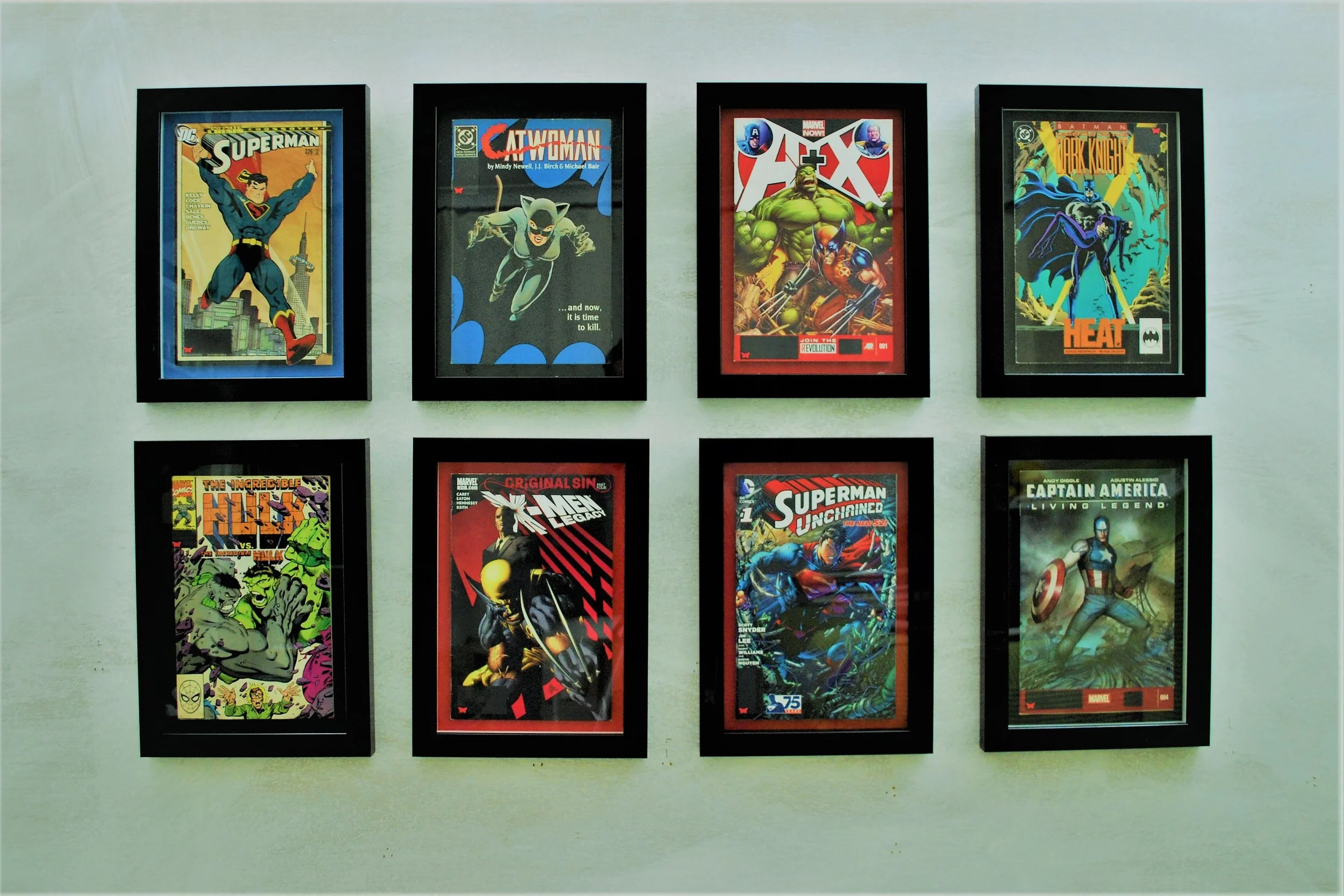 comic book classics, highlighted by colour mounts, float mounted and framed within a glossy black.