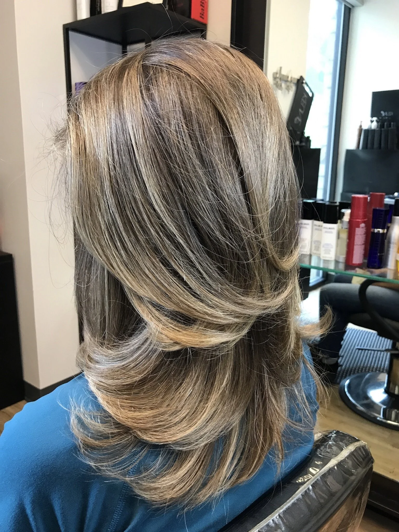 Brunette hair with subtle highlights and long layers for depth and movement in Dallas, Texas.