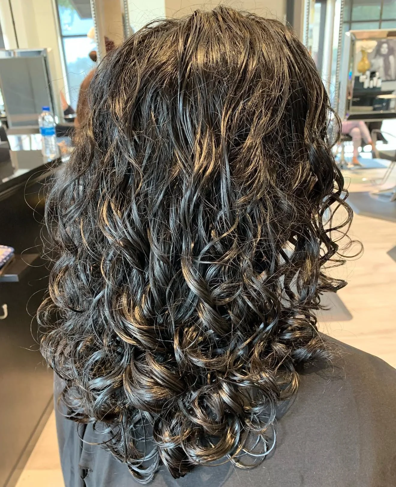 Curly hair specialist in Frisco TX shaping curls for definition and flow