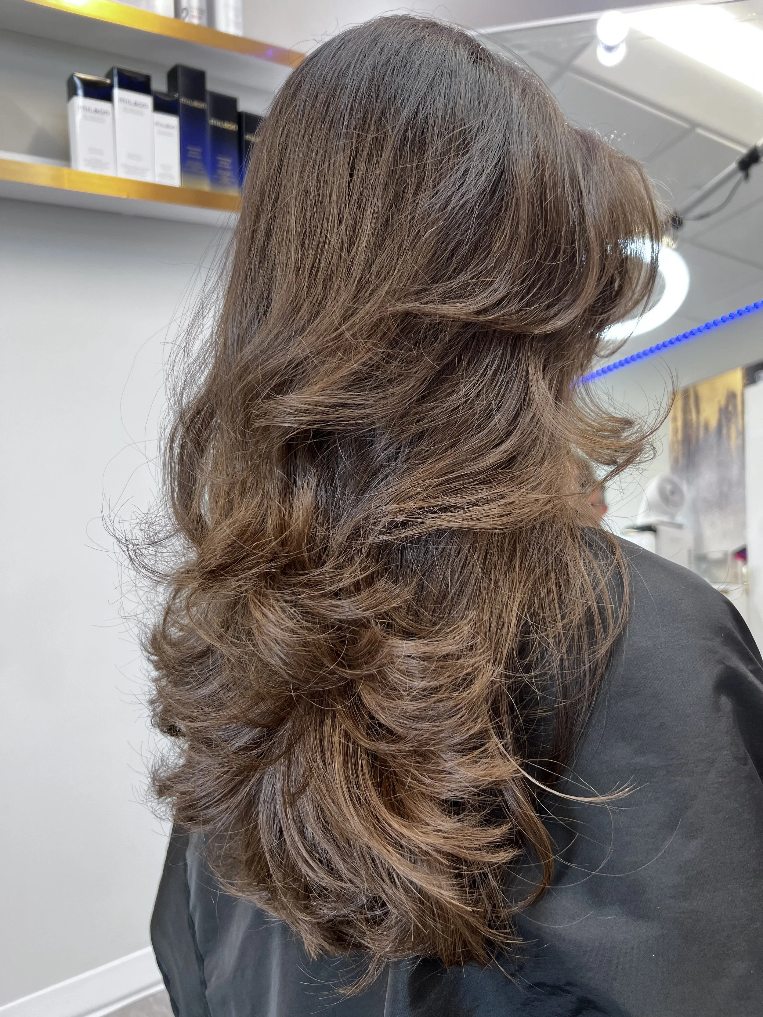 Long layered women’s haircut designed for fluid motion and soft dimensional flow