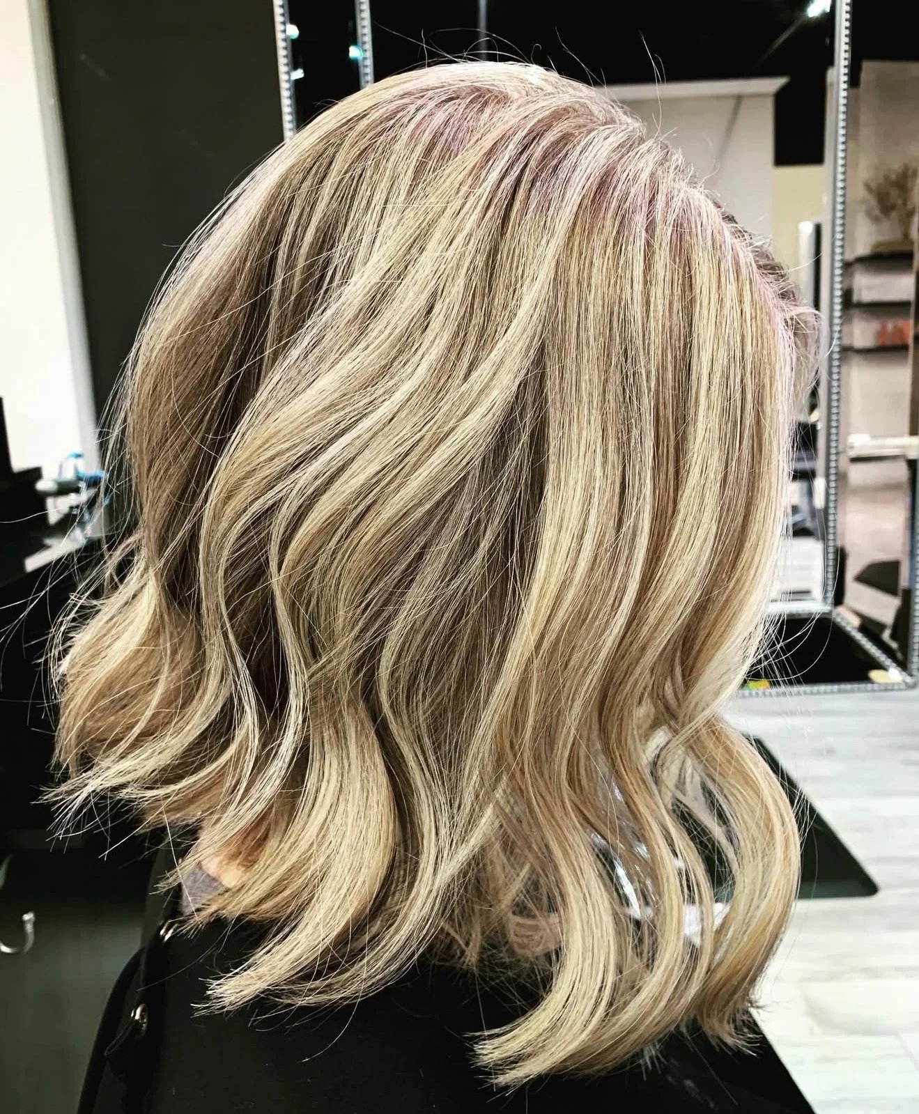 Soft natural-looking blonde highlights with precision lob haircut in Nichols Hills Oklahoma City