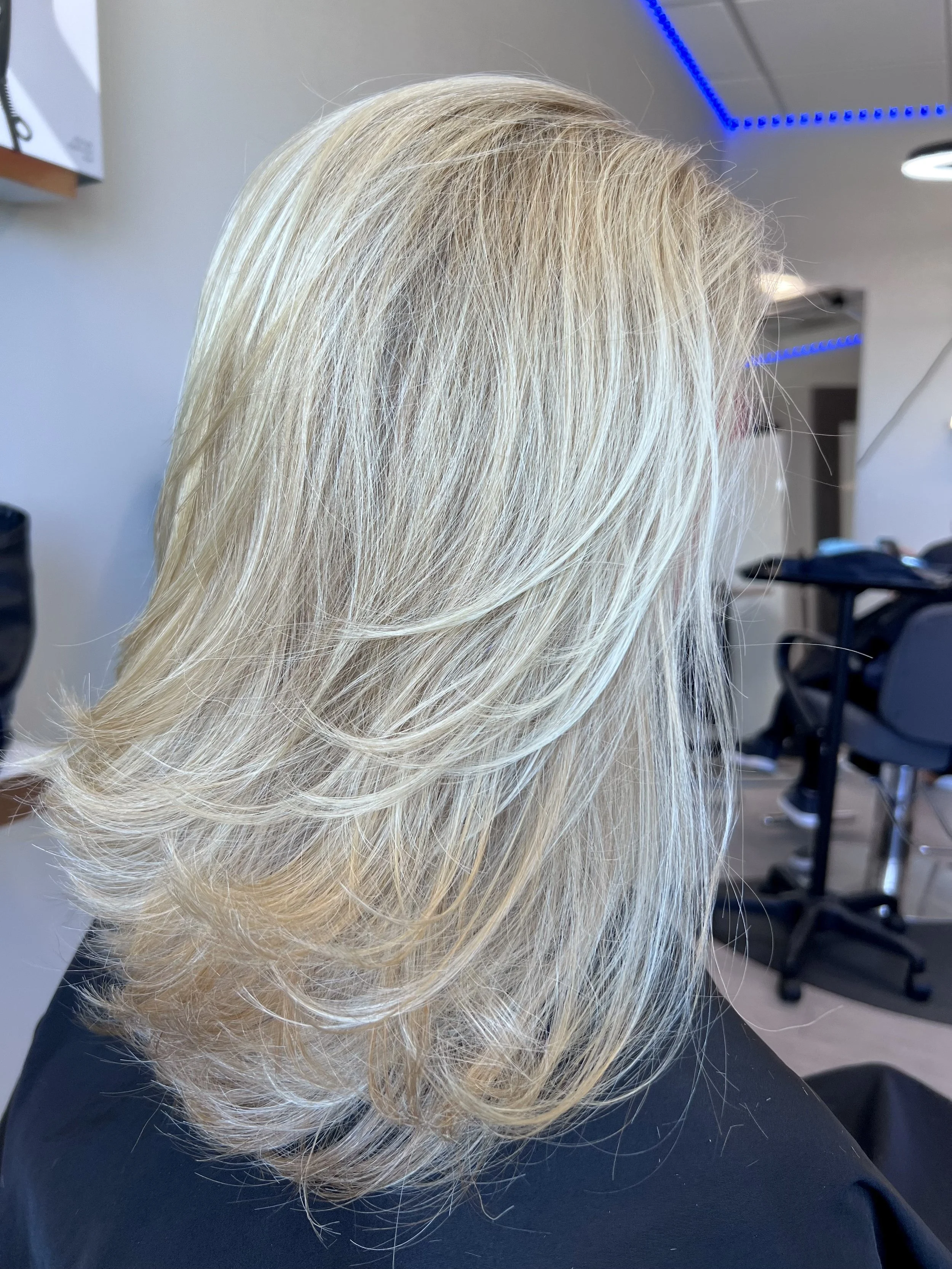 Natural blonde highlights with controlled dimension and soft layering, designed to enhance movement while maintaining depth and avoiding flat or washed-out color.