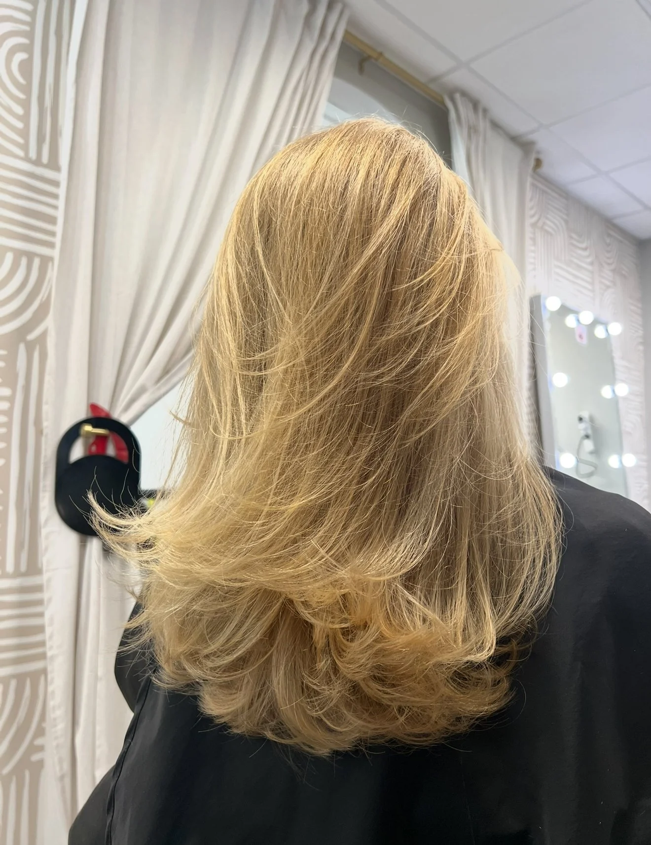 refined natural blonde highlights with a precision layered haircut in Nichols Hills Oklahoma City