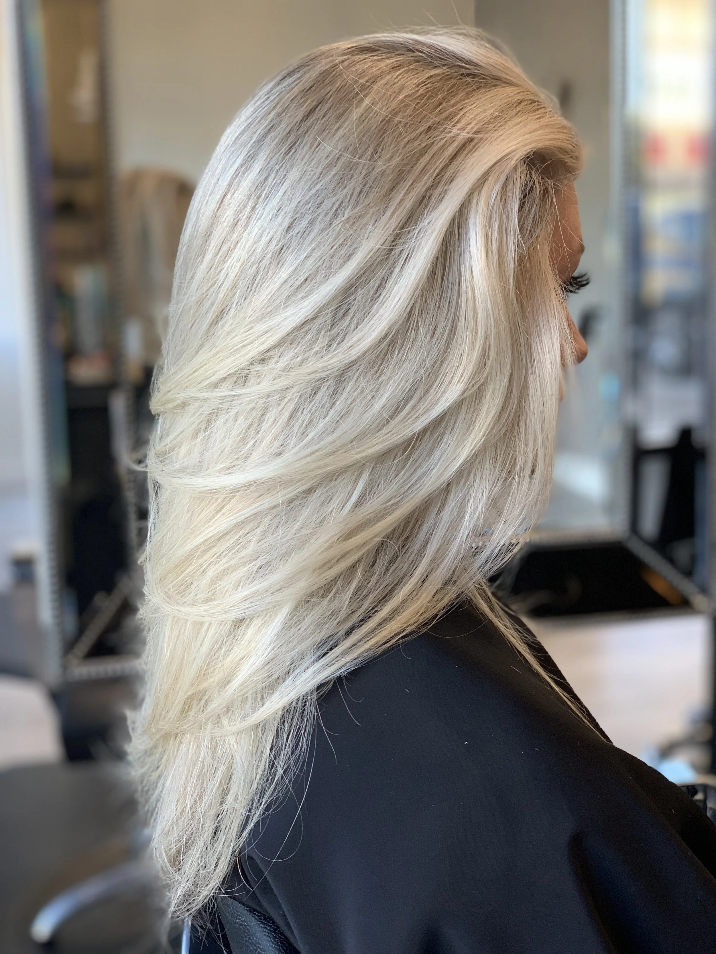 Icy blonde layered haircut with soft, seamless movement for fine to medium hair in Dallas, Texas.