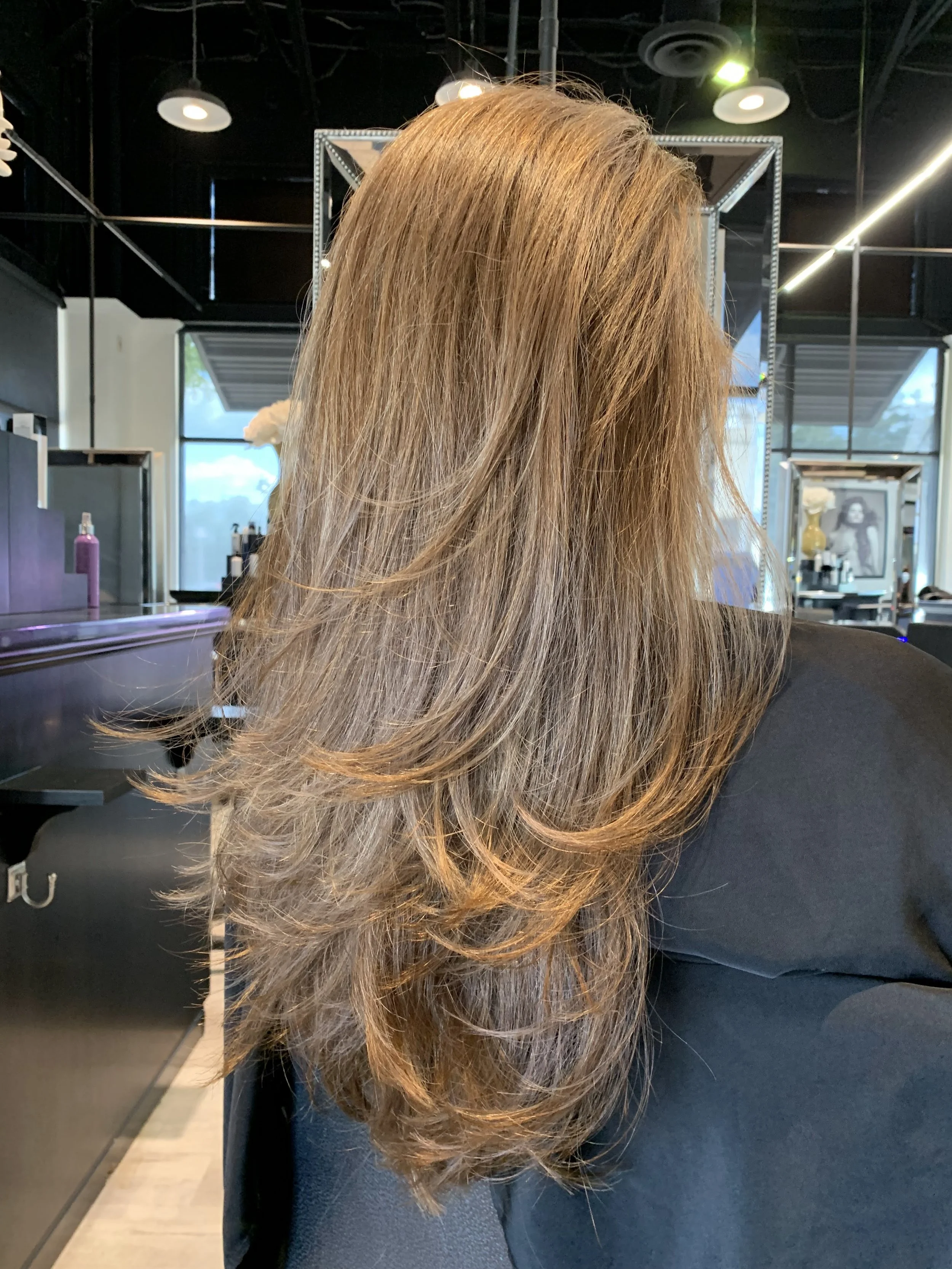 Long copper blonde layered haircut in Frisco Texas with soft movement and fluid shape