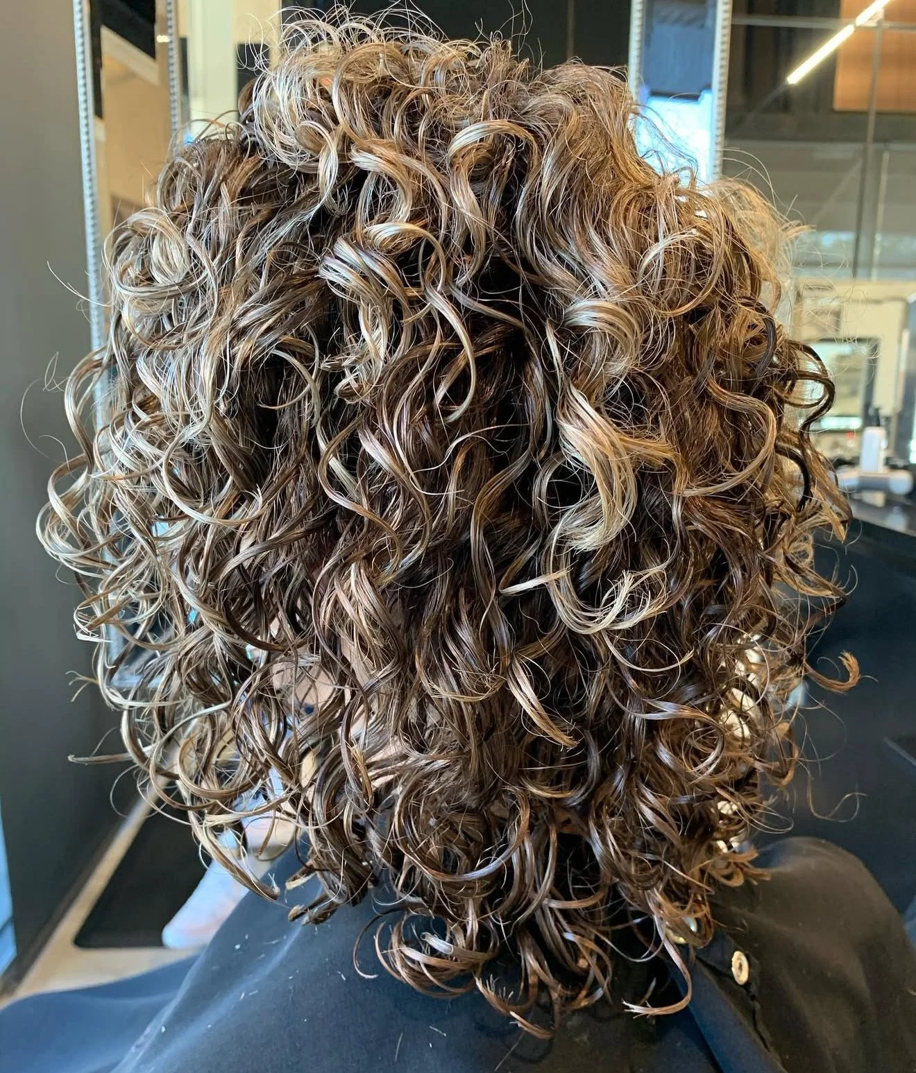 Curly haircut, root color touchup for grey coverage and natural-looking blonde highlights in Nichols Hills Oklahoma City by curly hair stylist Scott Risk
