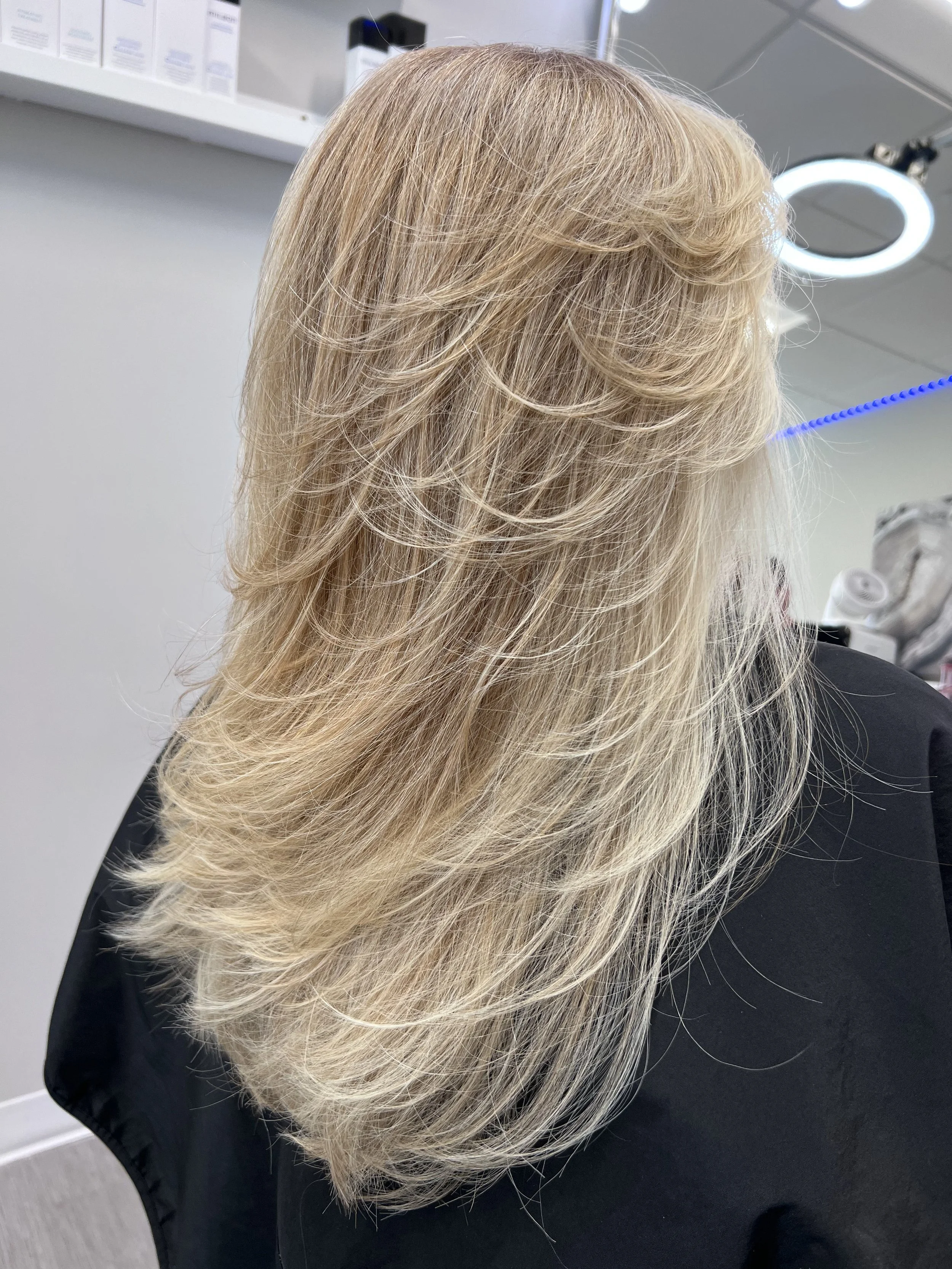 Dimesional blonde highlights and seamless layered haircut designed for movement in Nichols Hills Oklahoma City