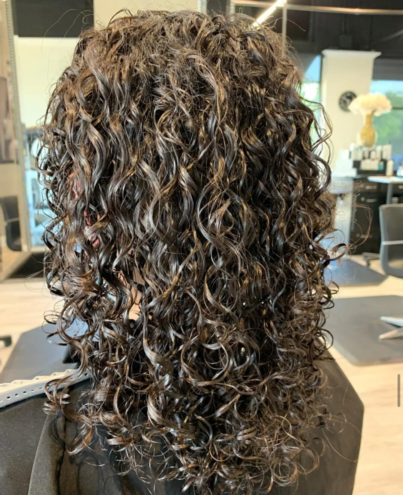Curly haircut in Frisco Texas with refined shape and soft curl finish