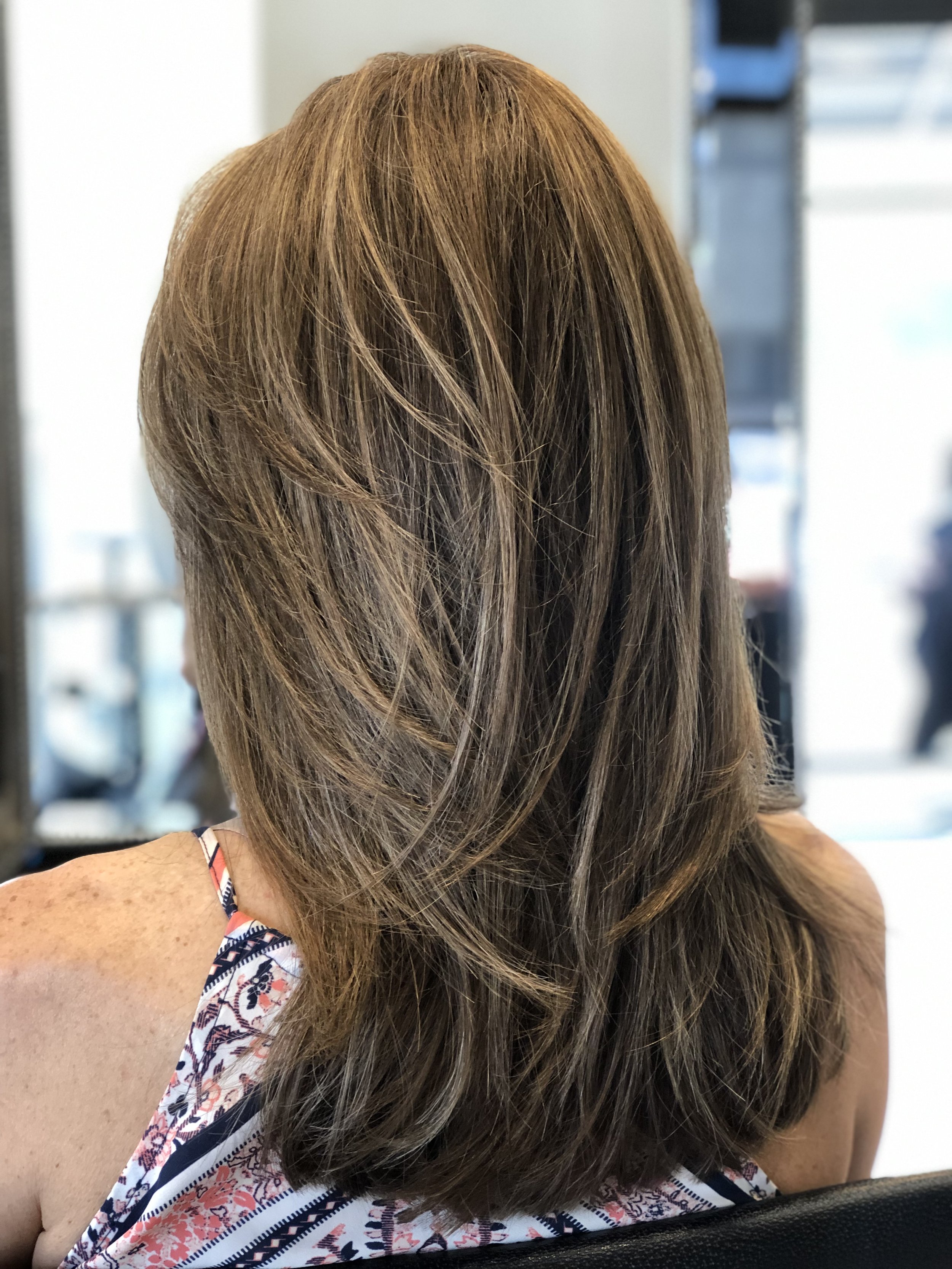 Long layered women’s haircut with balanced weight and seamless movement for fine to medium hair