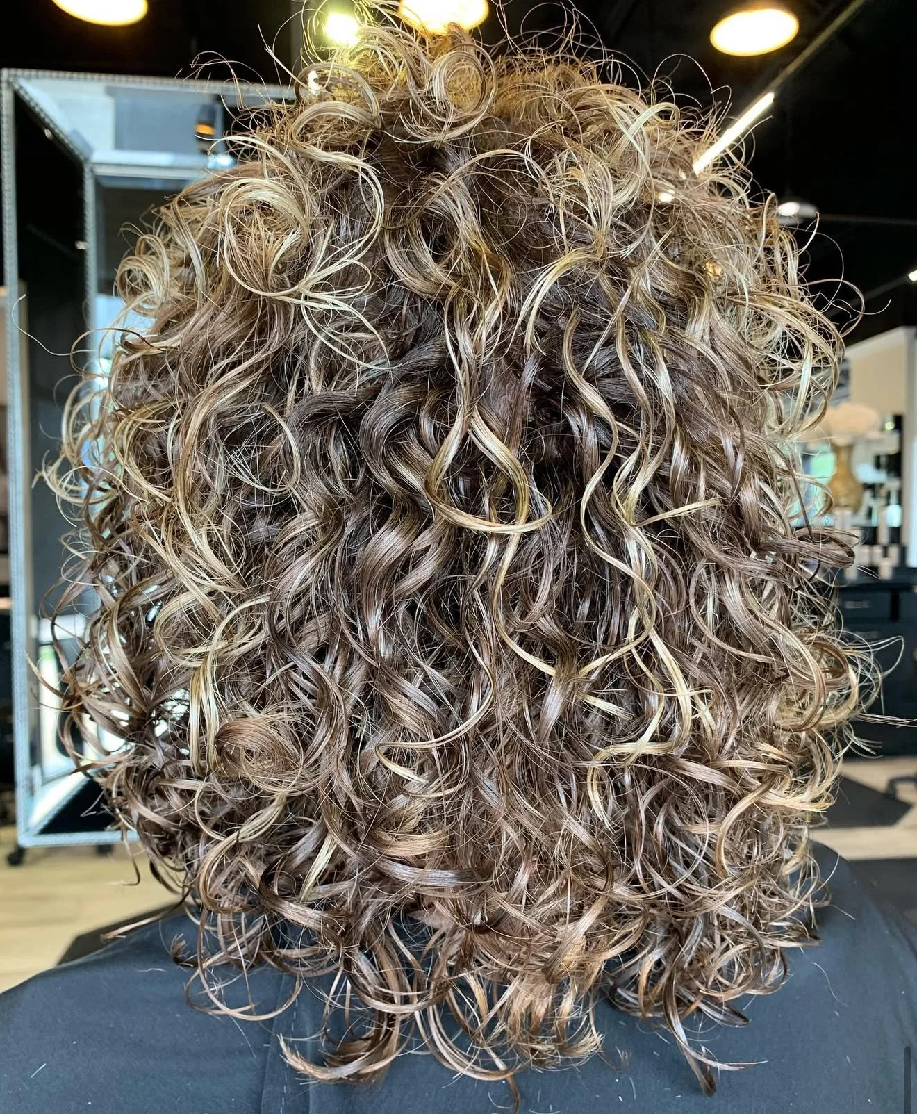 Frisco Texas curly haircut showing defined curls and balanced layering
