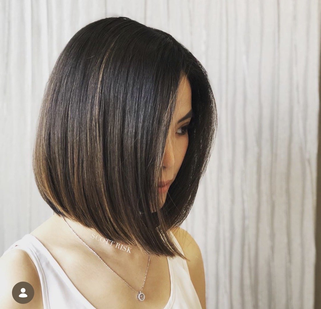 Precision angled bob haircut with sharp perimeter and sleek styling