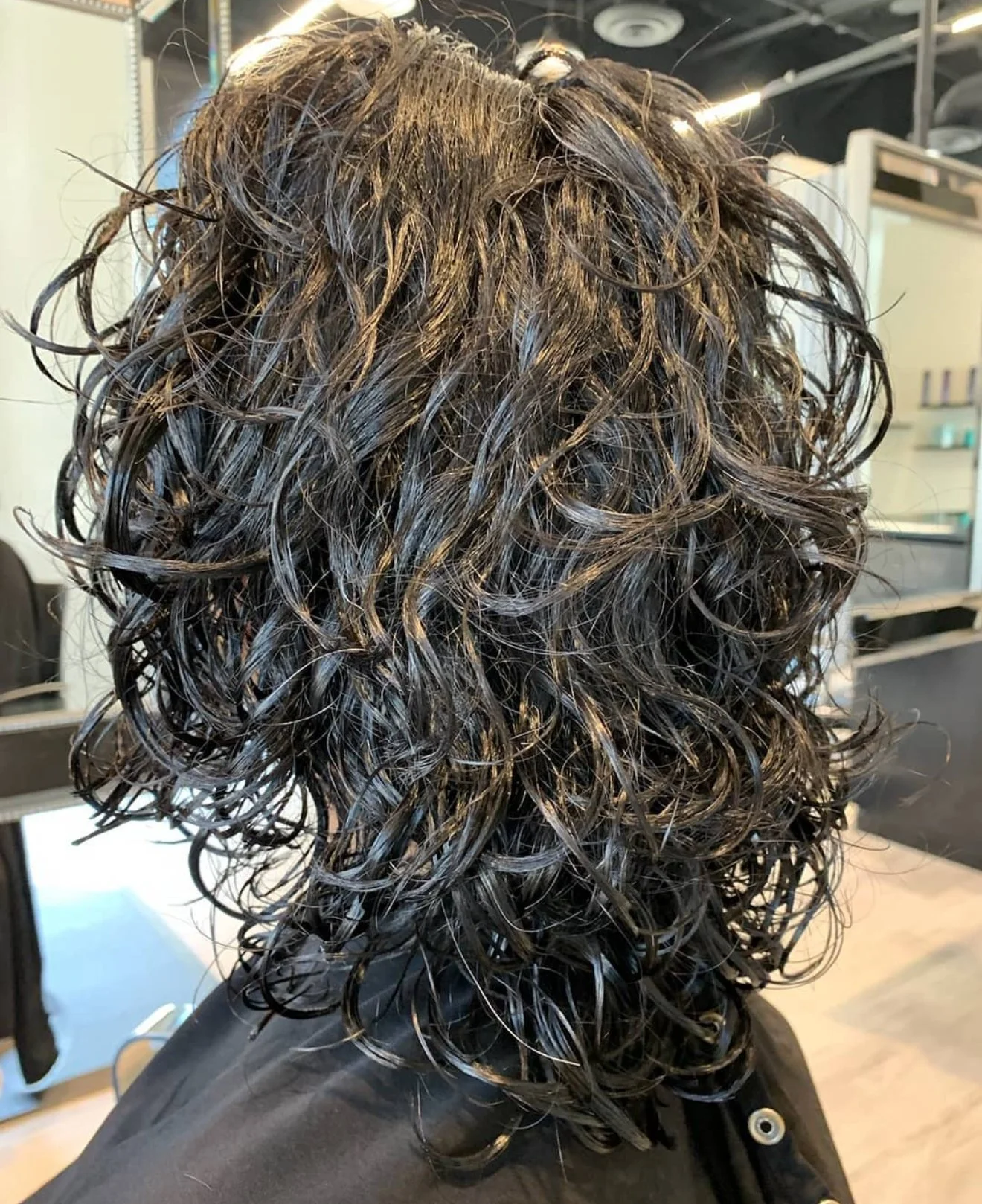 Curly cut with compact volume and defined curl structure for short curls