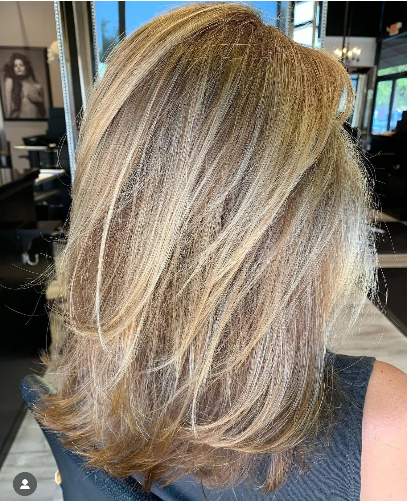 Natural-looking, sun-kissed blonde highlights and seamless layered haircut in Nichols Hills Oklahoma City