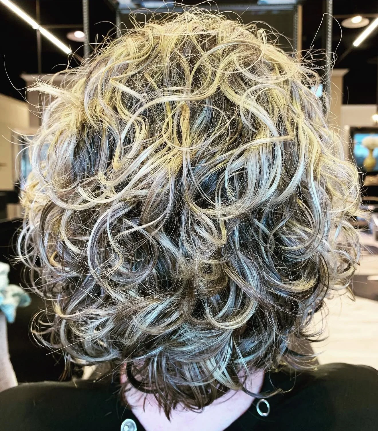 Light blonde wavy haircut with controlled shape and natural movement for fine to medium density hair — Frisco and Southlake Texas