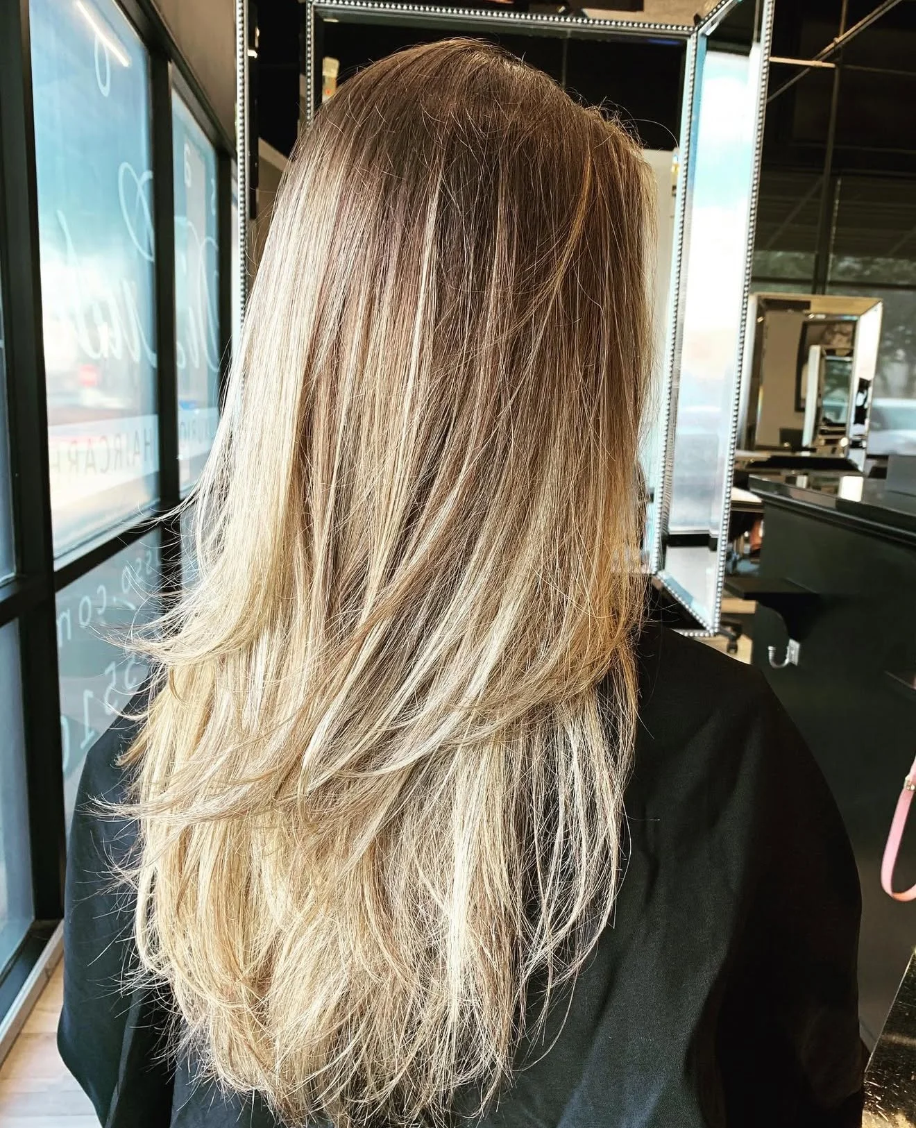 Blonde highlights with natural finish by Scott Risk with a clean layered haircut in Nichols Hills Oklahoma City