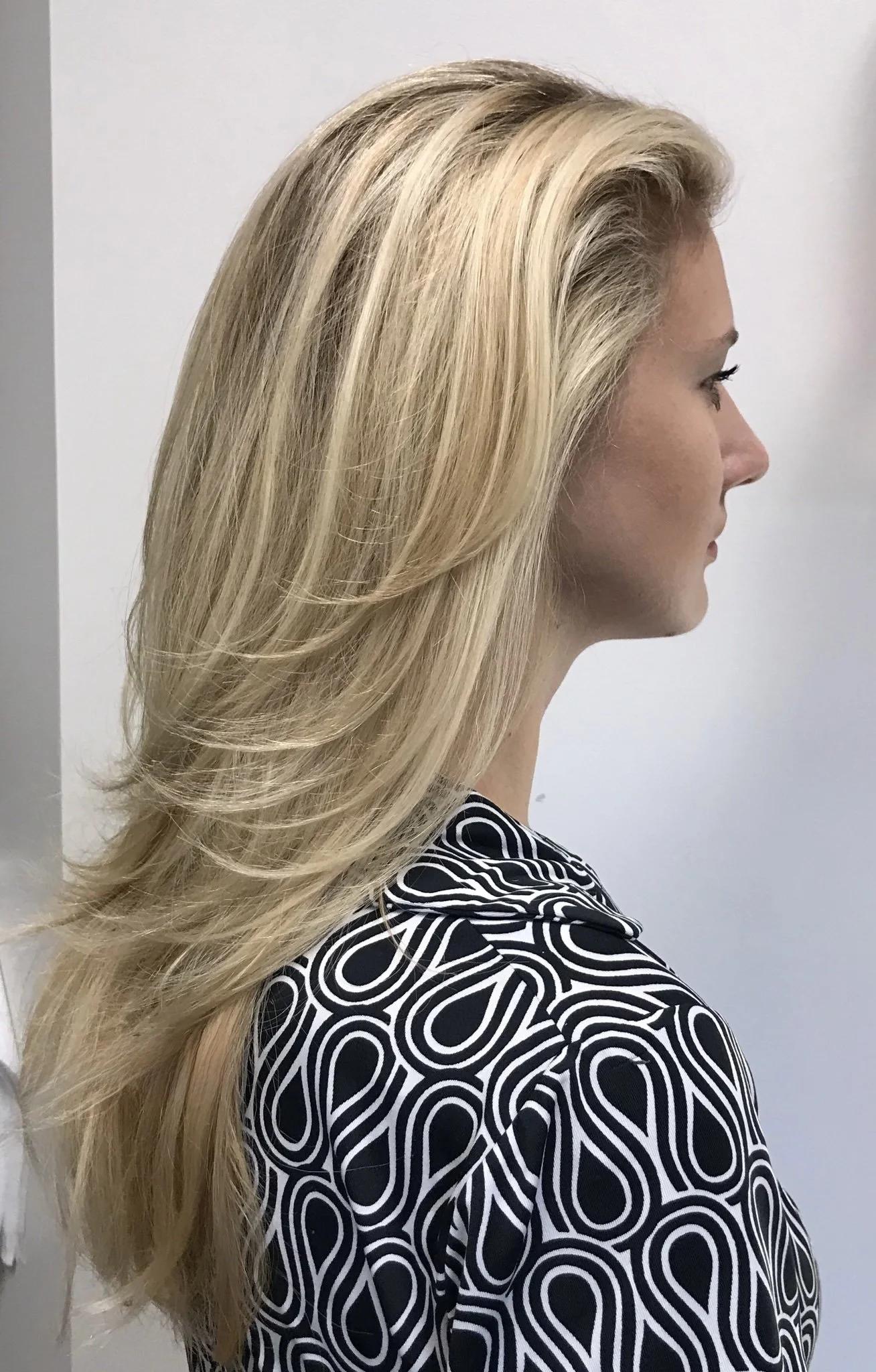 Long blonde layered haircut with light density in Nichols Hills Oklahoma