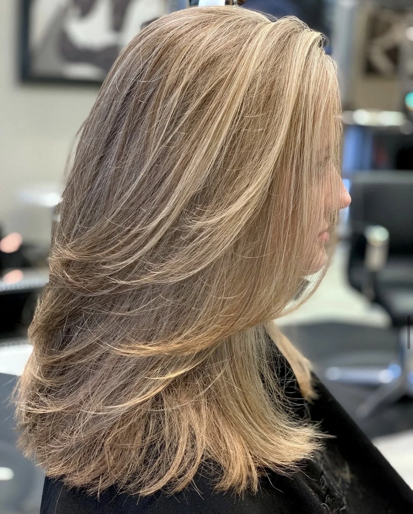 Soft beige blonde highlights shown in side profile with seamless placement and controlled dimension, designed for fine to medium hair with natural movement and clean tone.