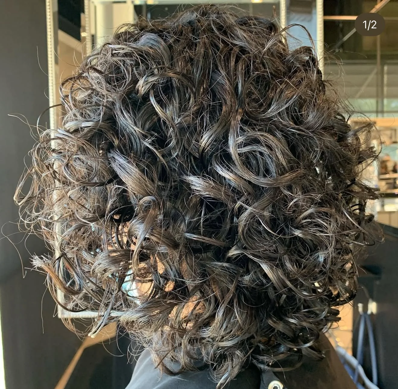 Defined curly haircut with layered shape in Nichols Hills OKC