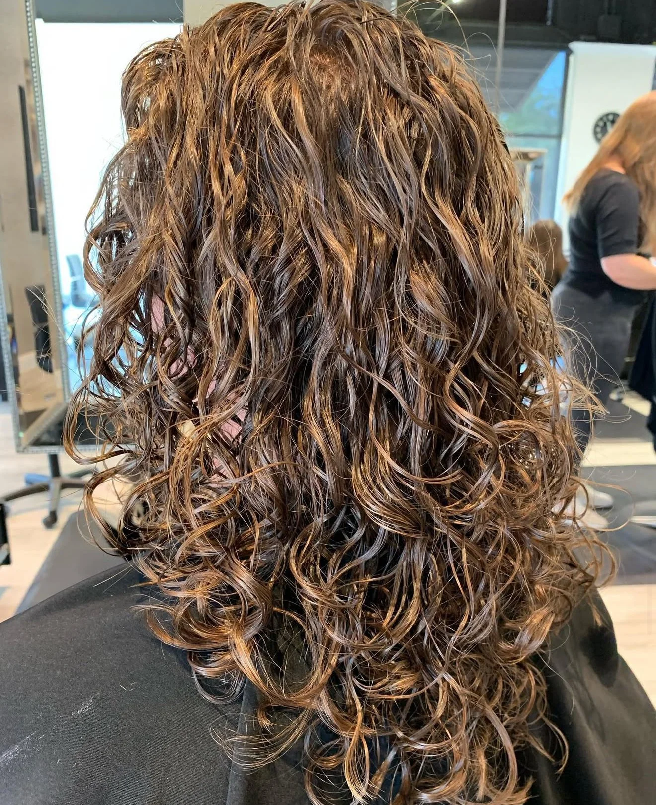Curly haircut with long layers and natural movement for textured curls