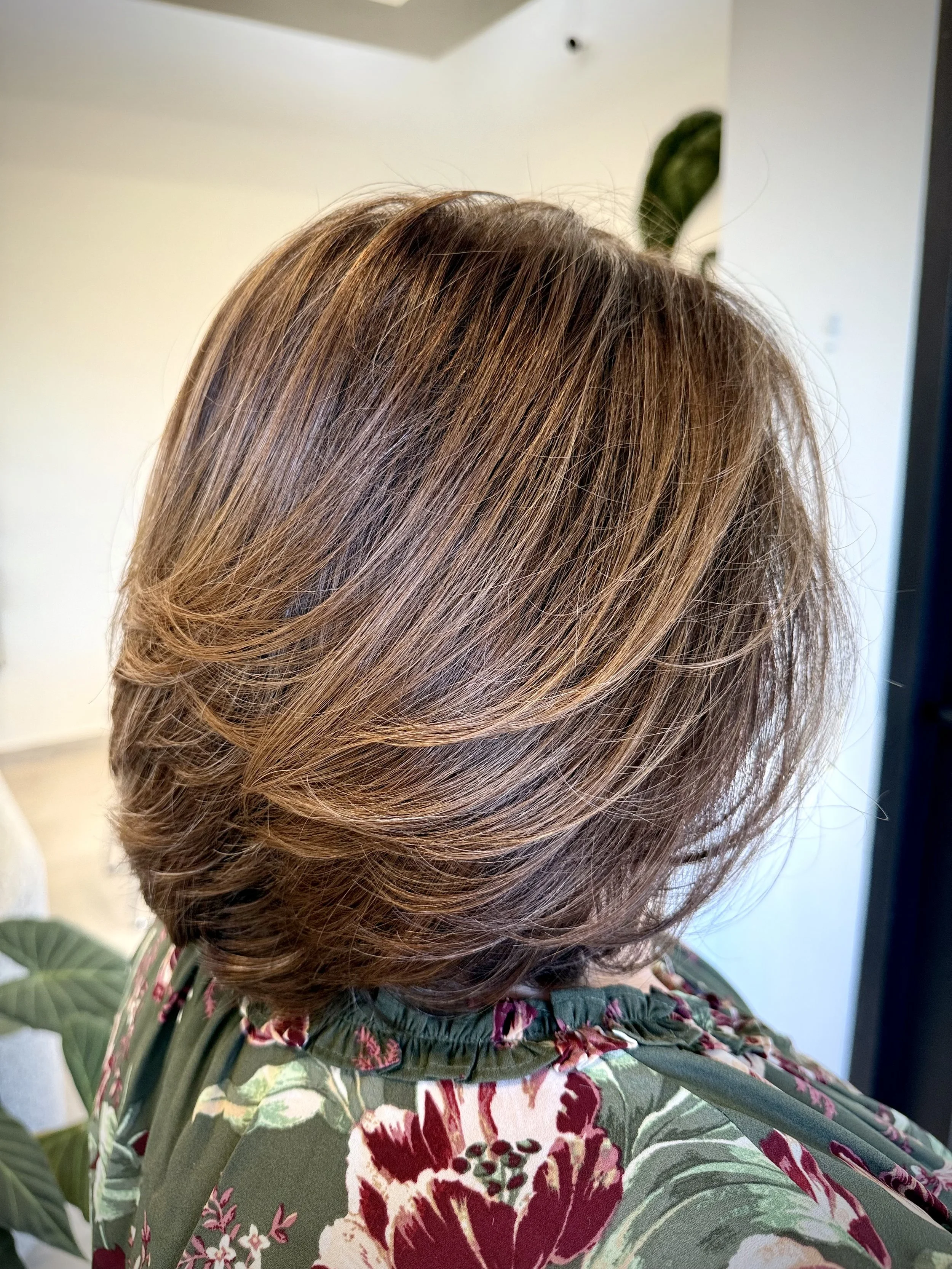 Layered bob haircut with volume, texture, and face-framing shape