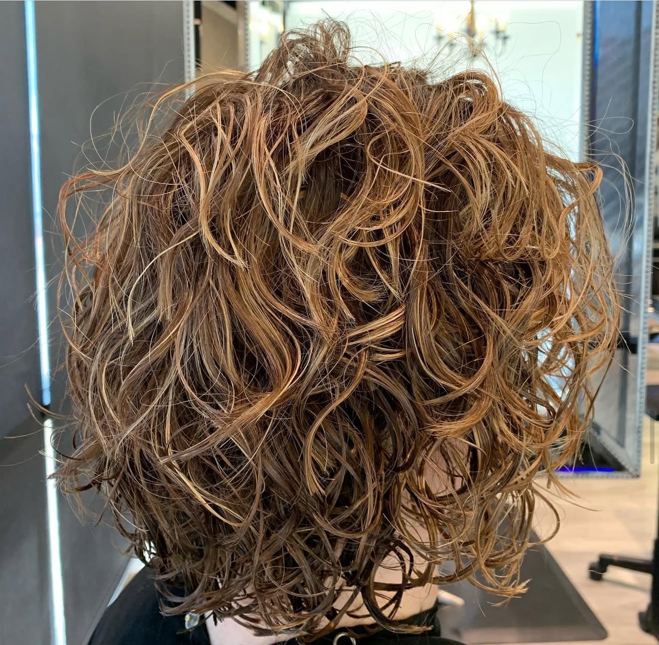 Frisco TX curly haircut with textured layers and controlled volume