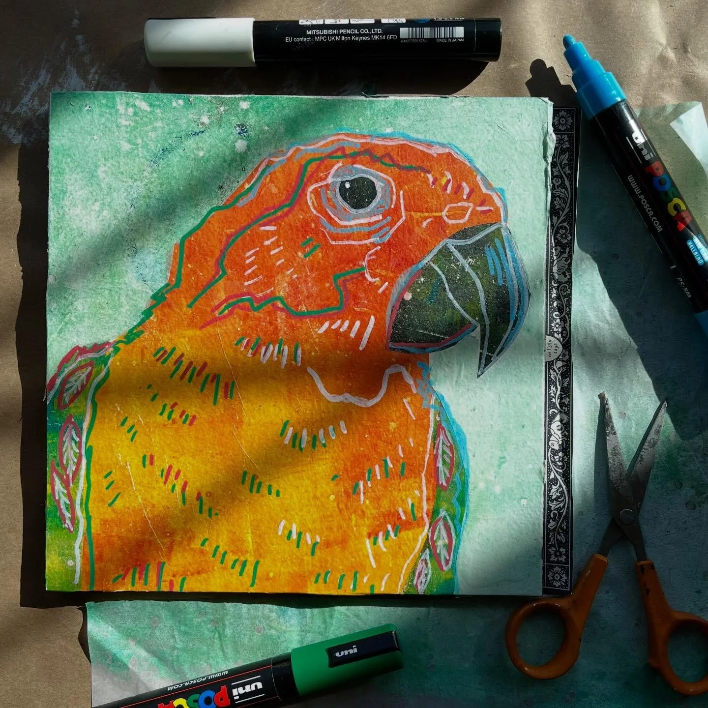 Experimenting with collage and paint pens. 🦜 🧡 Happy to have the sun in the studio on this super cold day.