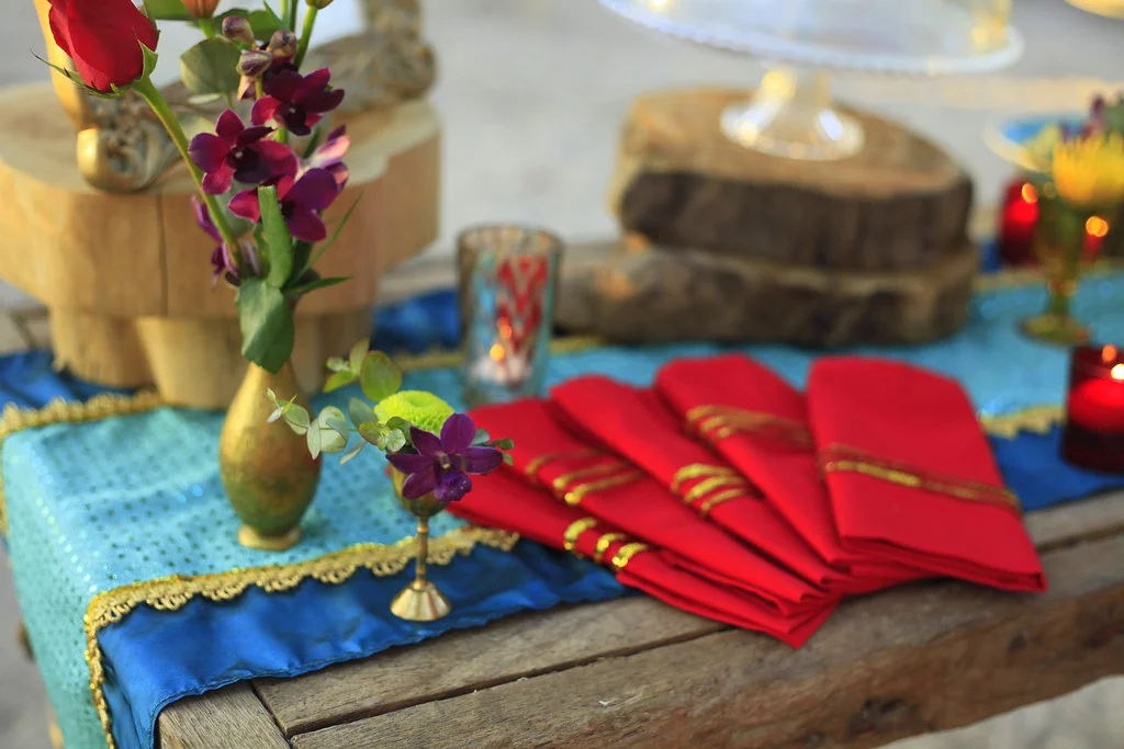Colorful napkins and wooden place setting accents during reception for Costa Rica beach wedding in Santa Teresa