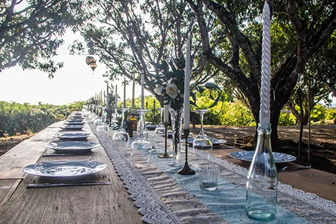 Blue rustic lace decor on a wood table during a reception for a Costa Rica beach wedding in Santa Teresa