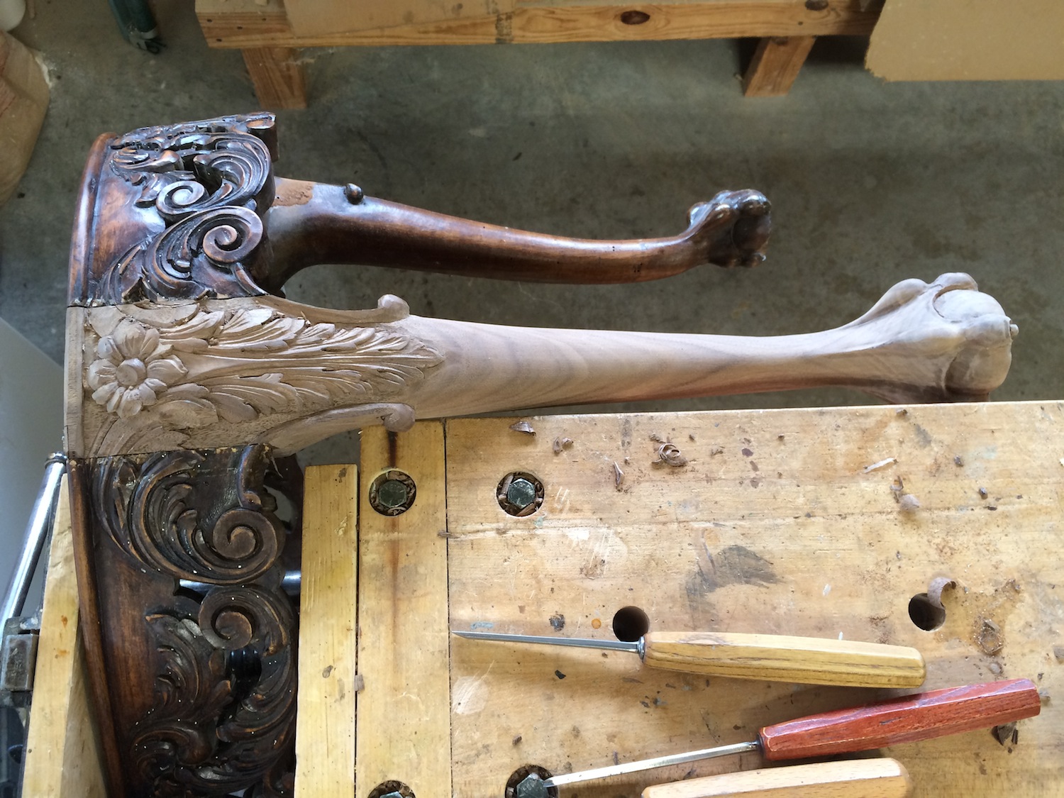   To replace the broken leg on this bench a new leg had to be carved and fitted to the existing joinery, then the decorative details merged with those of the apron.&nbsp; The new finish was applied in steps to achieve the proper color, shading and di