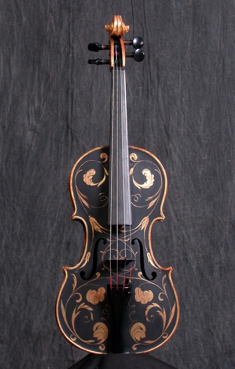   This violin was first gilded, then painted over with black egg tempera.&nbsp; My design was then scratched through the paint, revealing the leaf.&nbsp; This technique is known as  Sgraffitto , and is often seen on cassetta picture frames.  