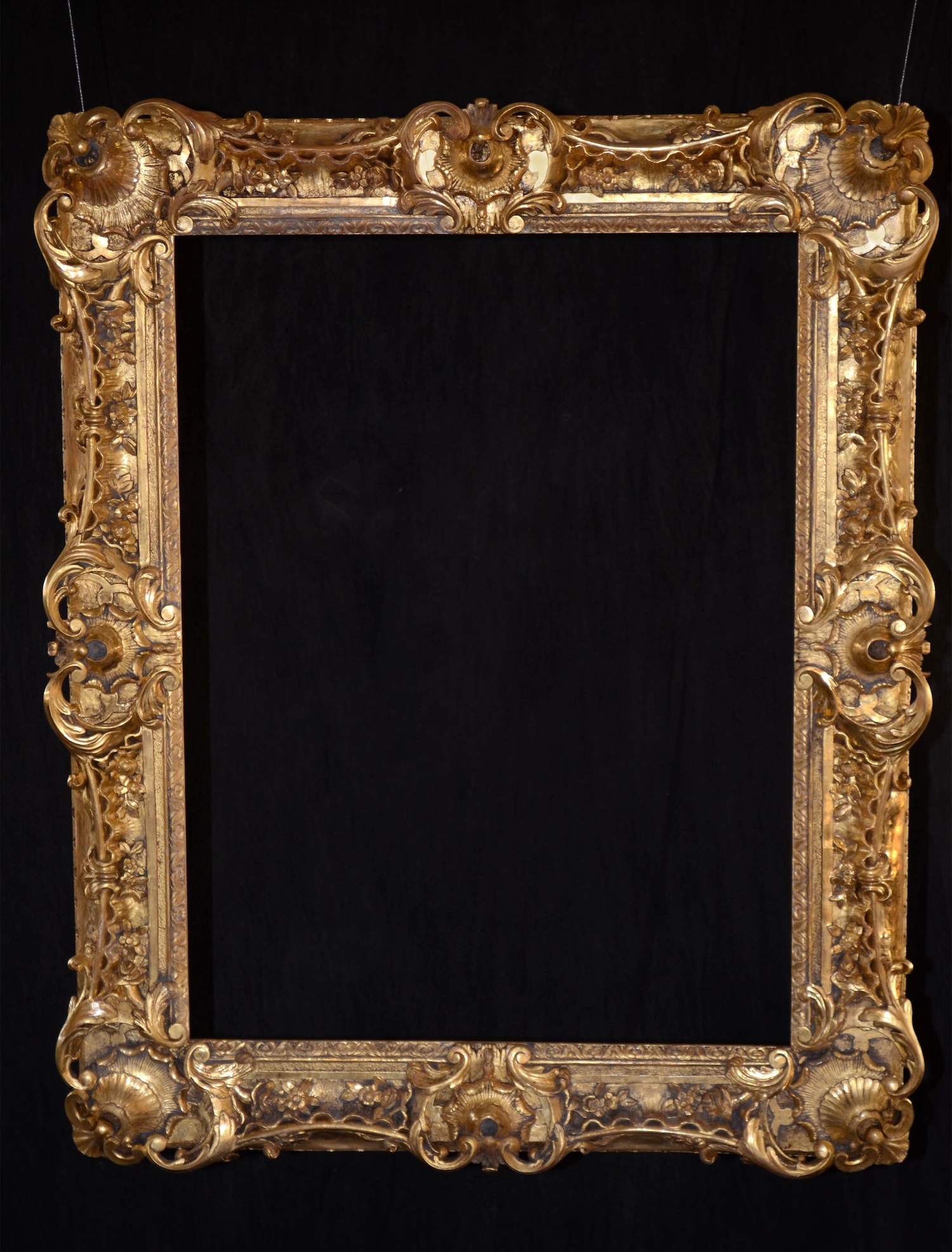   This rococo style frame measures 40" wide and 50" high.&nbsp; It was created using a single photograph provided by the customer.&nbsp; It is water gilt in 23 kt gold, burnished and distressed.&nbsp;  