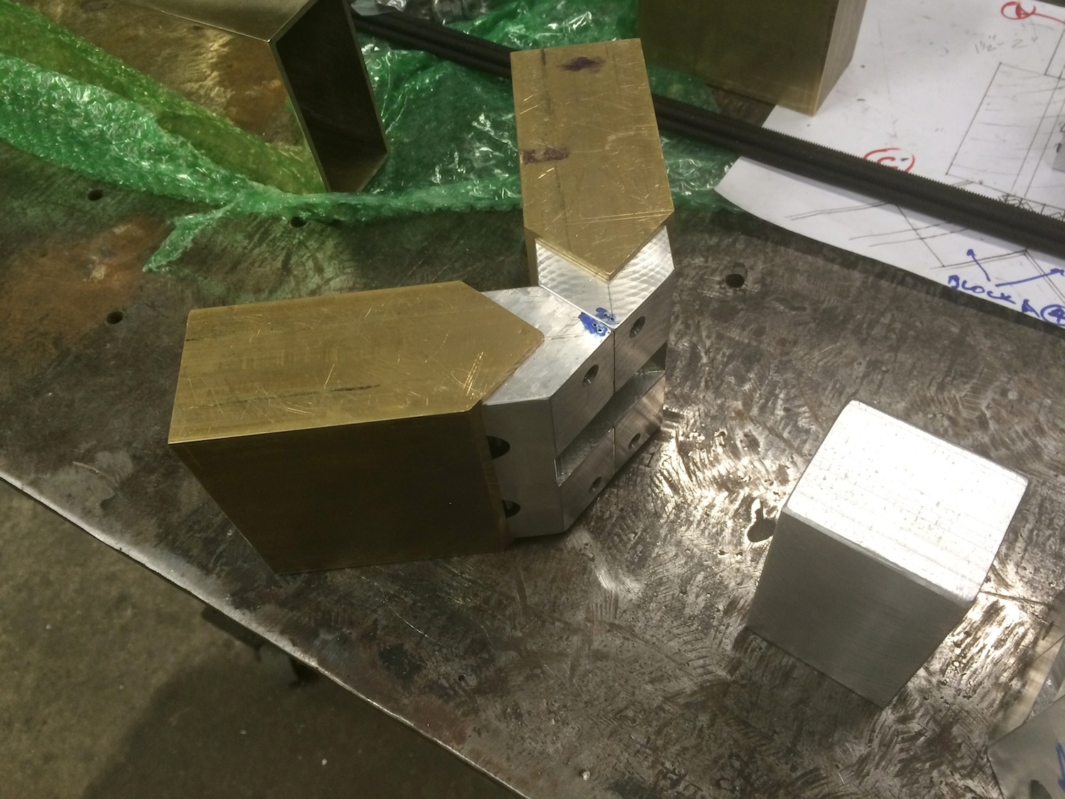   Testing the fit of the aluminum blocks that join the brass tubing at the miter and to the wood.  