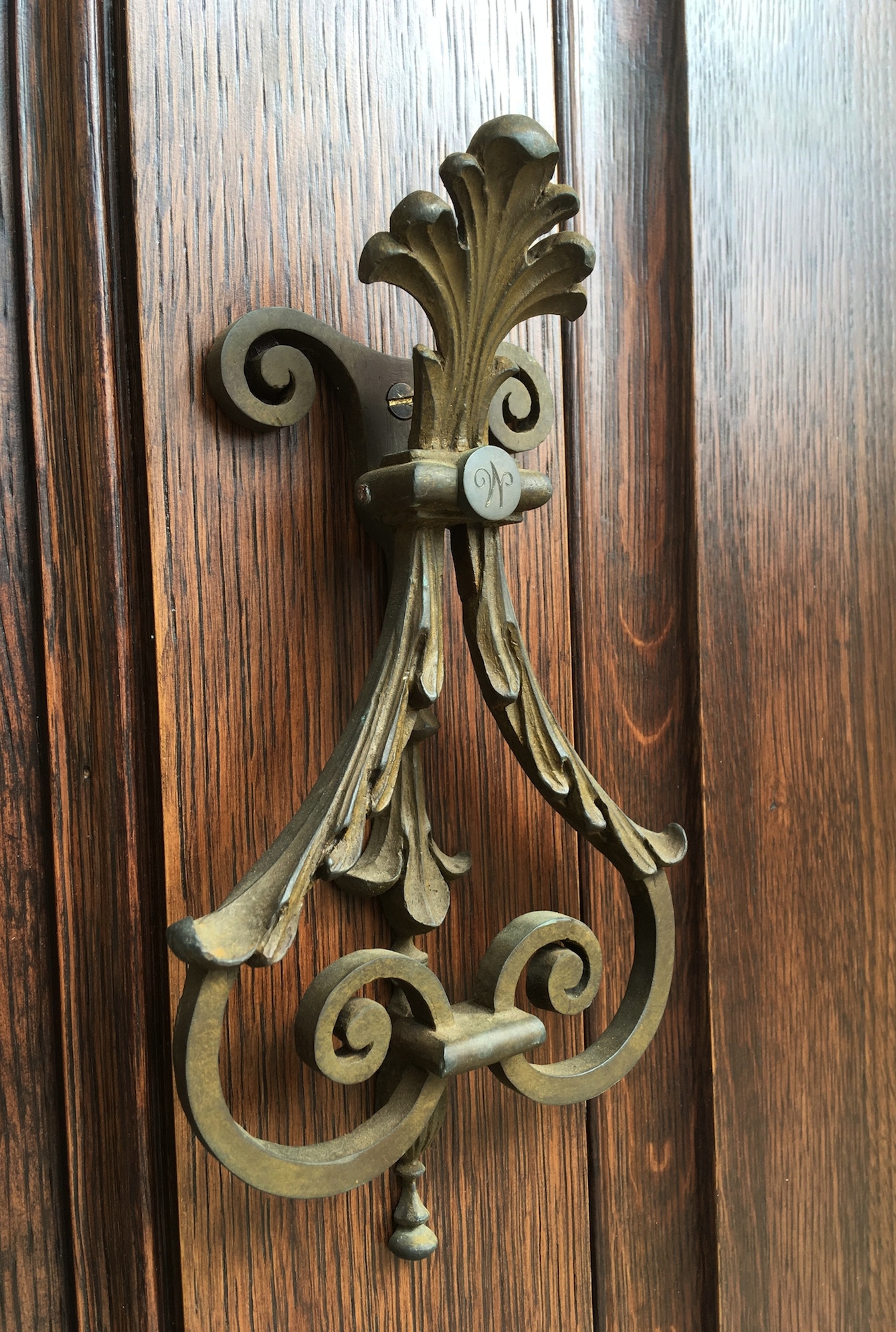   This door knocker is assembled from two lost wax castings.&nbsp; I carved a wooden model from the architect's drawings, the foundry used my model to make their molds.&nbsp; The two castings were then assembled and fitted with an engraved button.  