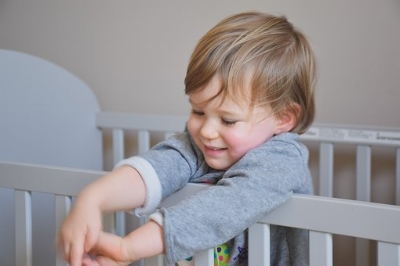 toddler boy standing crib.jpg