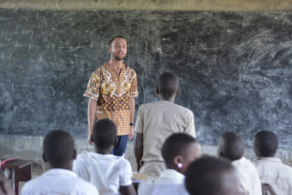  Ryan Blackwell works on English pronunciation with 7th-grade students in Agbatitoé, Togo.  
