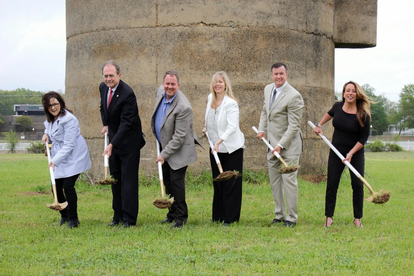 From left, Southaven Chamber Executive Director Carmen Kyle, Mississippi Secretary of State Delbert Hosemann, developer Brian Hill and wife Debbie Hill, Southaven Mayor Darren Musselwhite and City Planning and Development Director Whitney Choat-Cook officially turn dirt in the Silo Square groundbreaking Tuesday morning in front of the silo that will become the iconic center of the commercial and residential development.