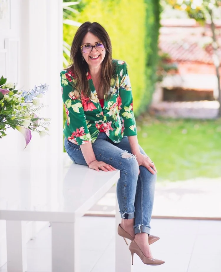 Michelle Carvill… seen here sitting on a table.